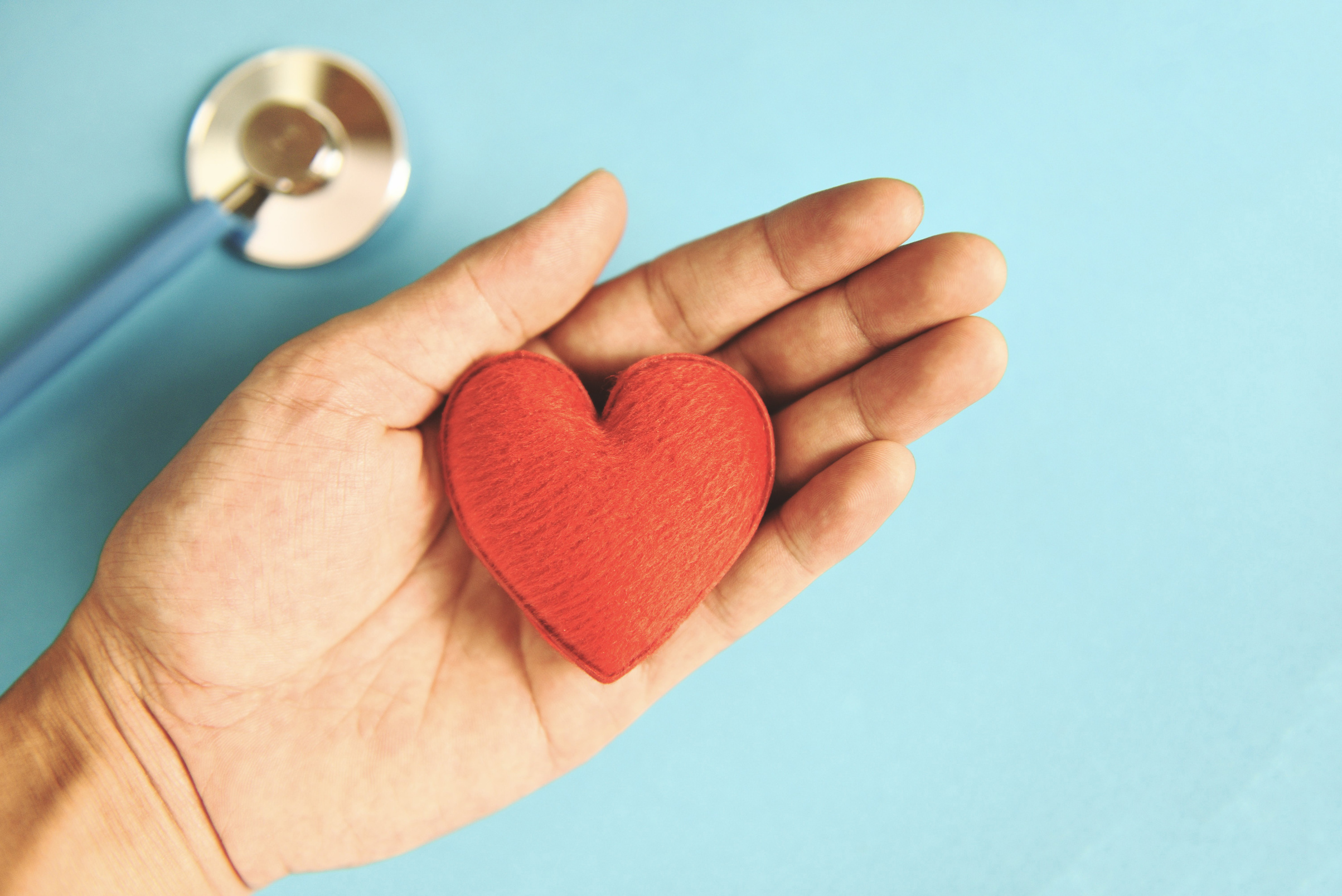 Insurance Health Concept - Stethoscope and Red Heart in Hand